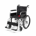 Lightweight folding transport wheelchair with aluminum frame and swing-away footrests on white background
