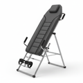 Full-body inversion therapy table with padded backrest shown at inversion angle on white background